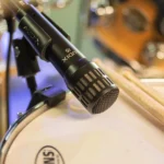 AUD 4-piece drum microphone package mounted on drum kit with kick, tom, and overhead placement