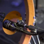 AUD 8-piece drum microphone package showing all included microphones and accessories laid out