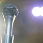 AUD AX OM5 professional dynamic vocal microphone shown from side profile angle