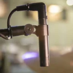 AUD professional studio cardioid condenser microphone showing capsule and acoustic design features