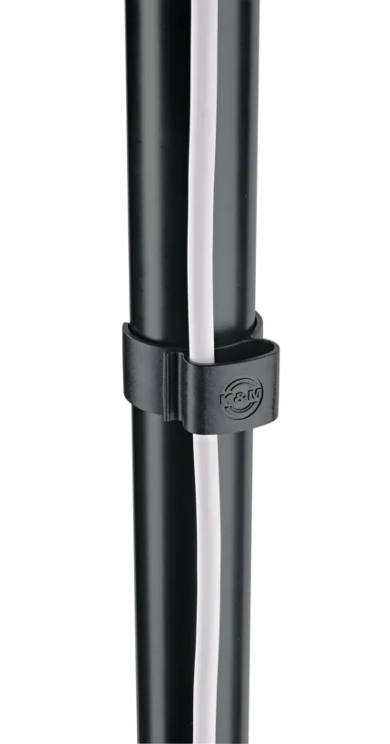 K&M black cable clamps installed on speaker stand securing audio cables