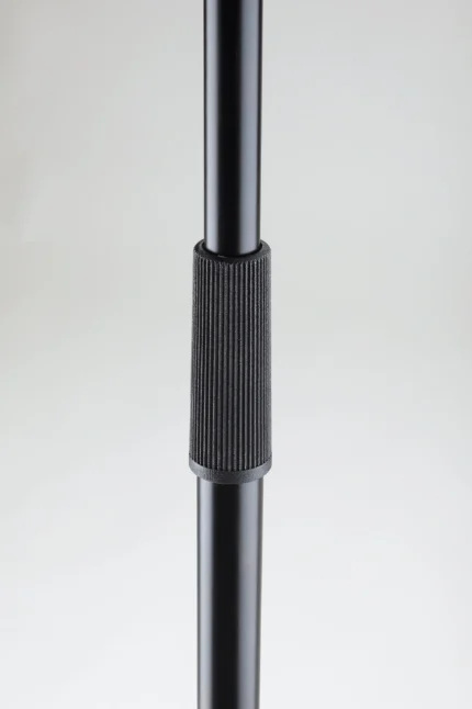 K&M black microphone stand shown from side angle with adjustable boom arm and weighted base