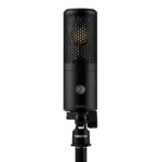 Shure KSM32C/HM condenser microphone mounted on stage with professional audio equipment setup