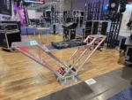 ProX VERRAZANO V-shaped aluminum truss DJ table with elevated monitor shelves and 24-inch base plate in professional setup