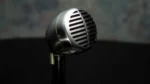 Shure AD2 SM58 handheld wireless microphone transmitter showing side profile and control interface
