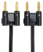 Hosa SKZ-630 black speaker cable coiled on stage floor with amplifier and speaker system